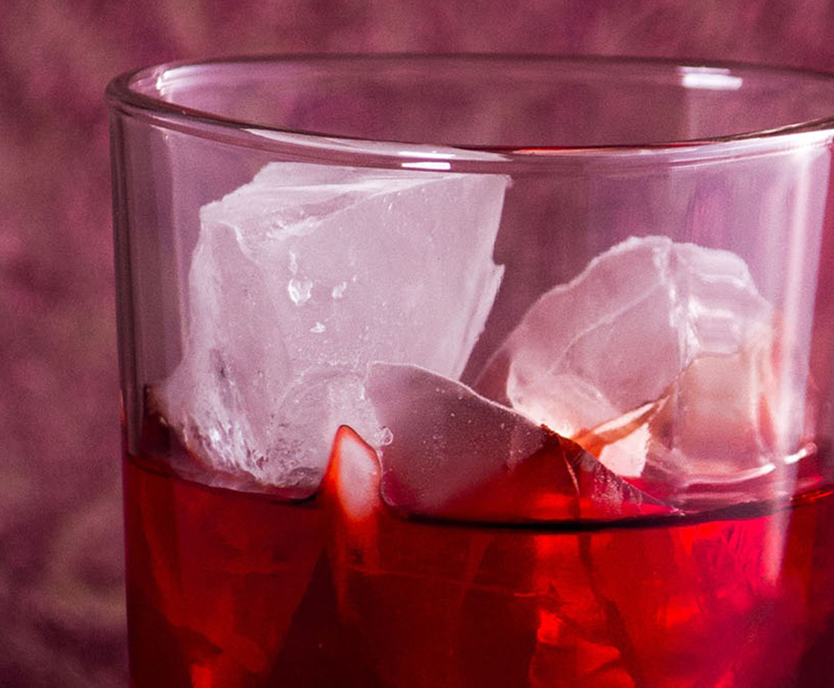 Das Bild zeigt ein Cocktailglas mit Eis und Getränk.